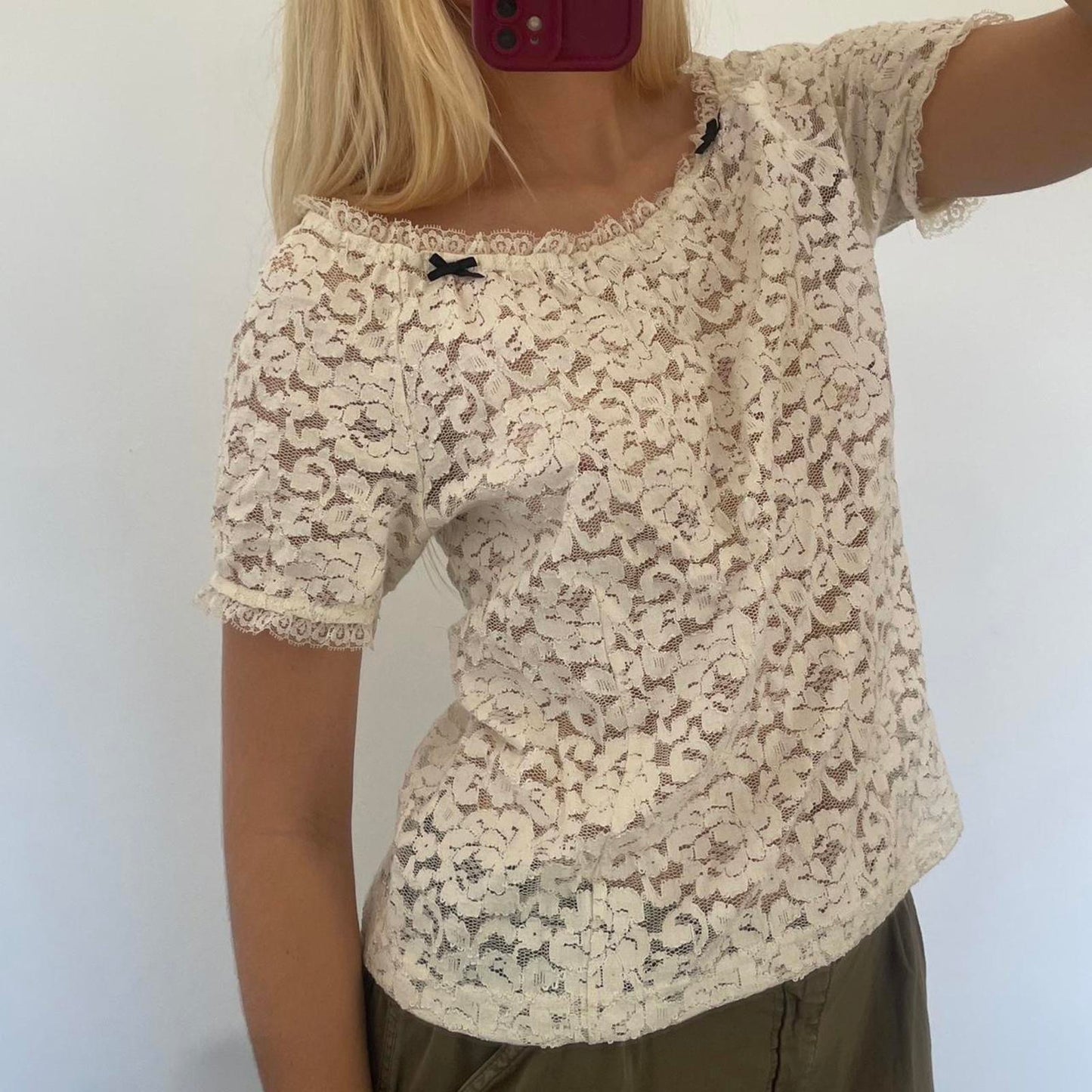 Cream lace off shoulder top with black bow detail, versatile