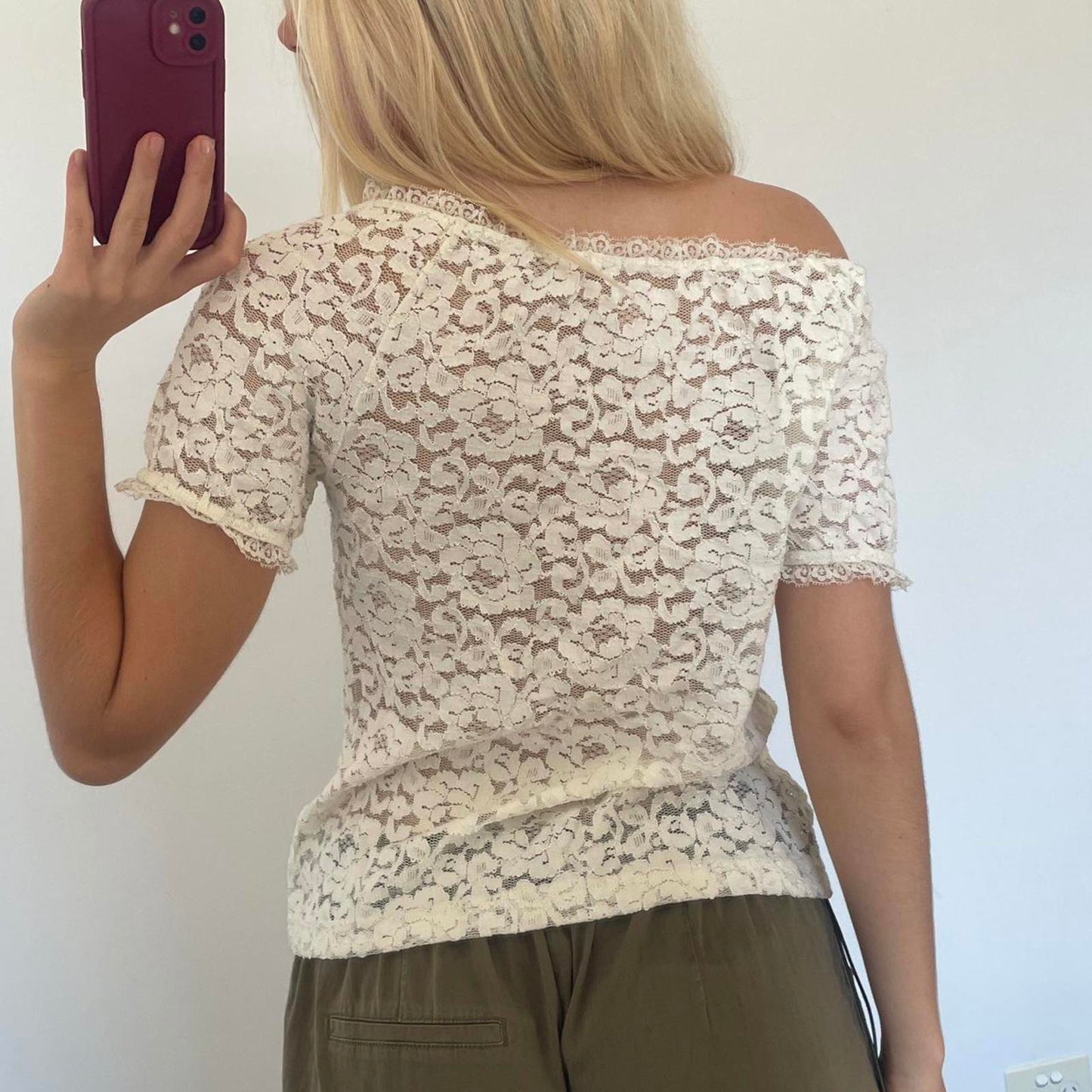 Cream lace off shoulder top with black bow detail, versatile