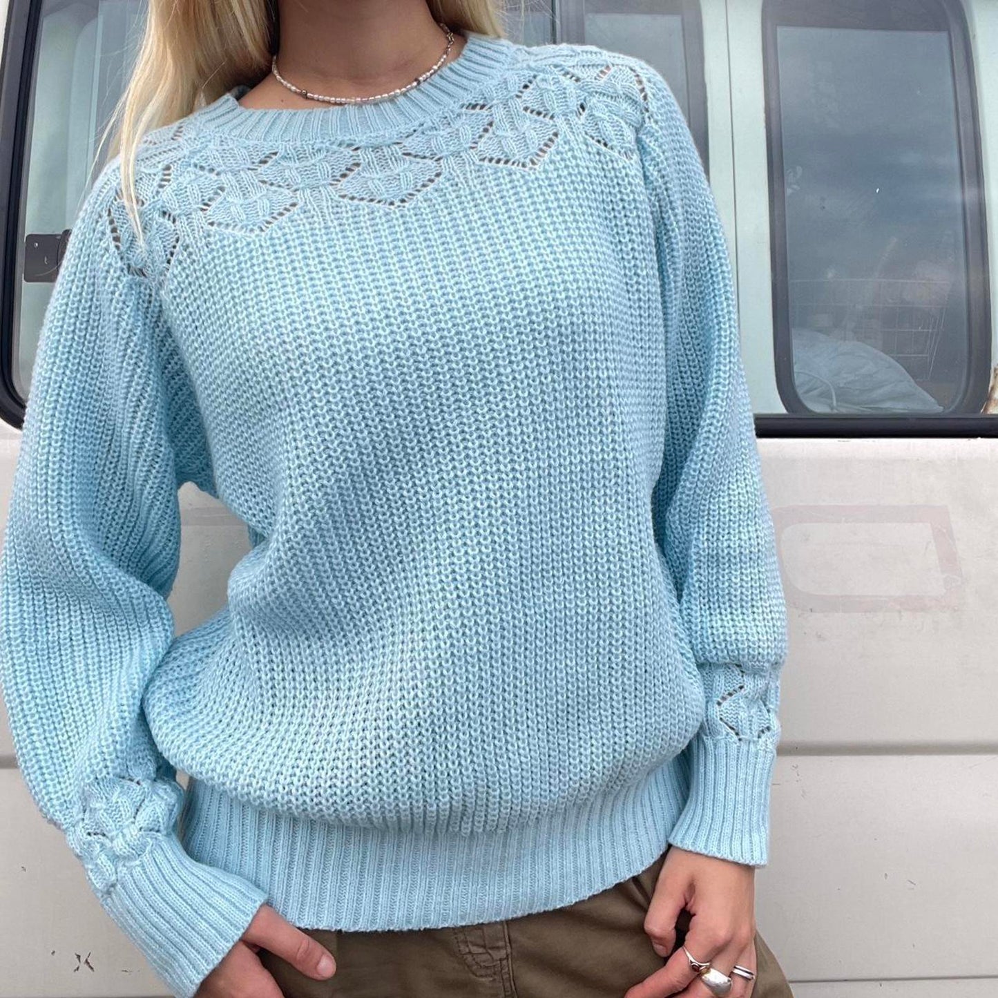 Baby blue knit sweater with a cute pattern on the front