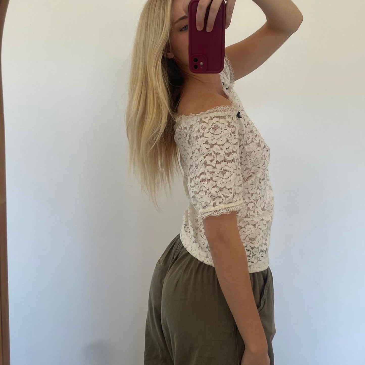 Cream lace off shoulder top with black bow detail, versatile