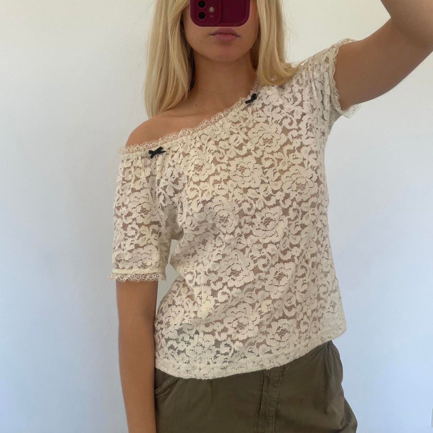 Cream lace off shoulder top with black bow detail, versatile
