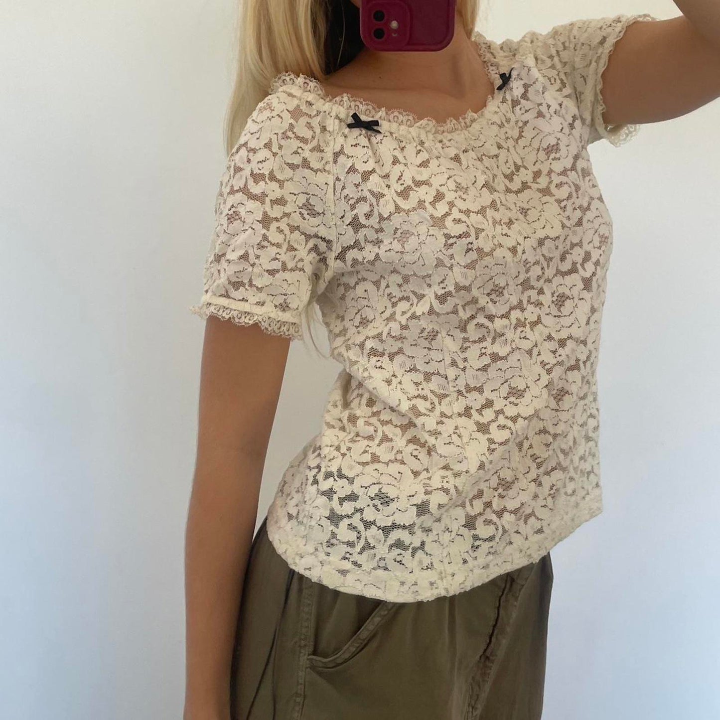 Cream lace off shoulder top with black bow detail, versatile