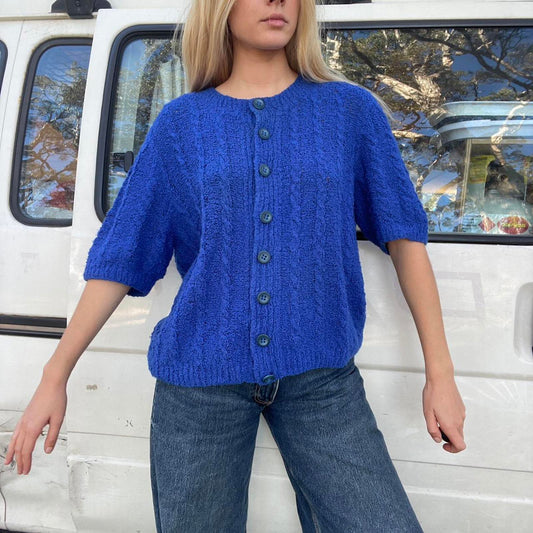 Blue knit button-up sweater with a preppy vibe